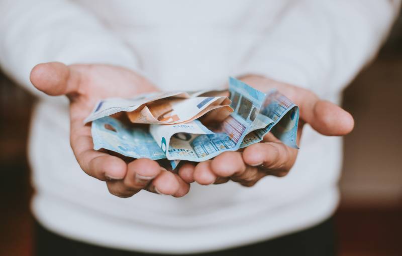 man holding cash in his hands