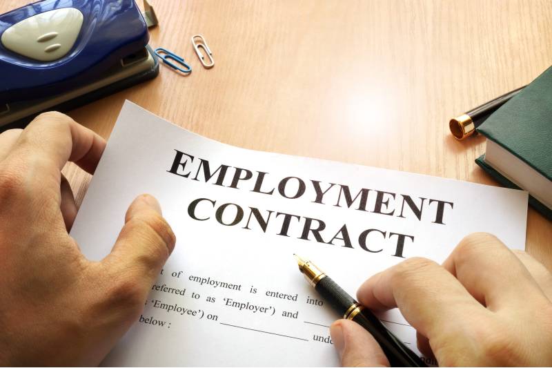 hands holding an employment contract