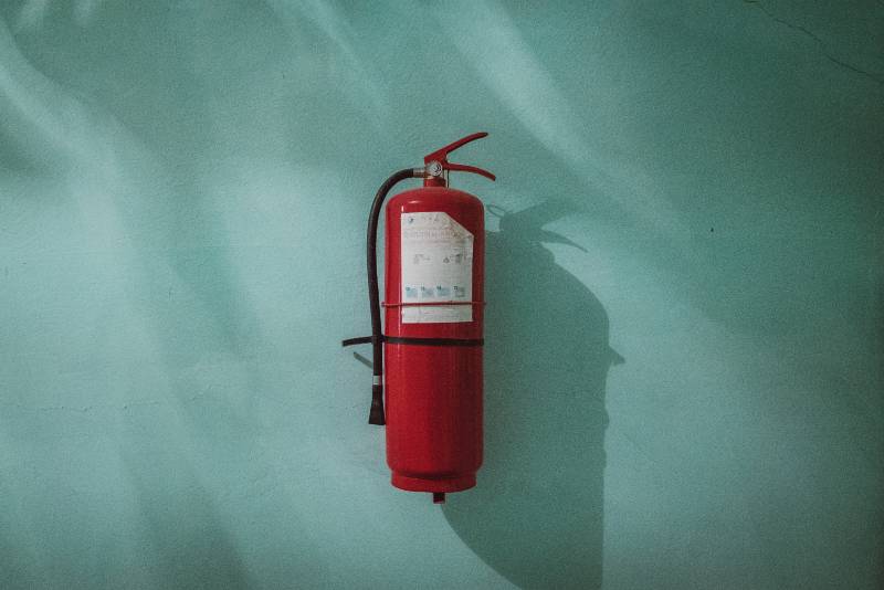 red fire extinguisher on a wall